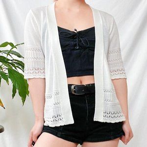 Crochet-style cropped open knit cardigan.